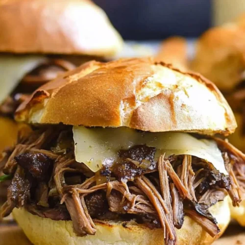 Shredded leftover beef chuck roast sandwich with Swiss cheese on a toasted French roll – a comforting and easy beef roast recipe.