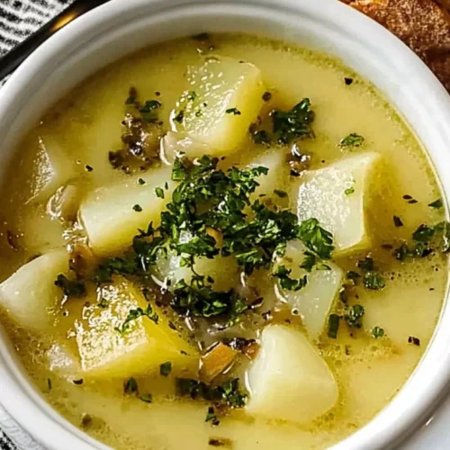 Easy Roasted Garlic Potato Soup 4 Bowl of roasted garlic potato soup topped with fresh parsley, served with bread on the side.