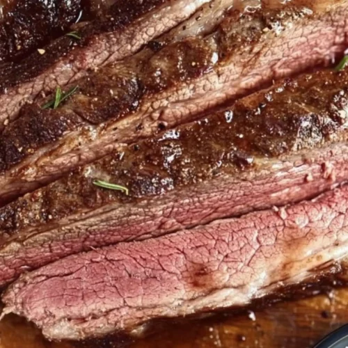 keto beef chuck roast recipe 4 Sliced keto beef chuck roast on a wooden cutting board, cooked medium with a juicy, tender texture